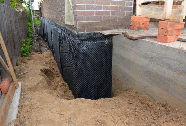 Happy homeowners after waterproofing job in Roann